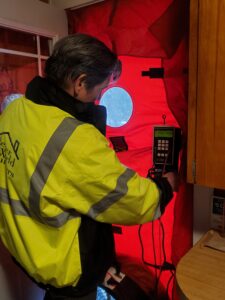 image of Better World Builders owner, Mark Lee, conducting a Blower Door Test.