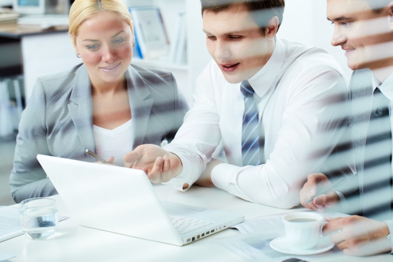 What Indoor Air Quality Accessories Can Help Keep Me Healthy? Image is a photograph of a group of coworkers working together at a desk.