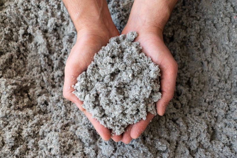 Pair of hands holding a pile of insulation. What Type of Insulation Do I Need?